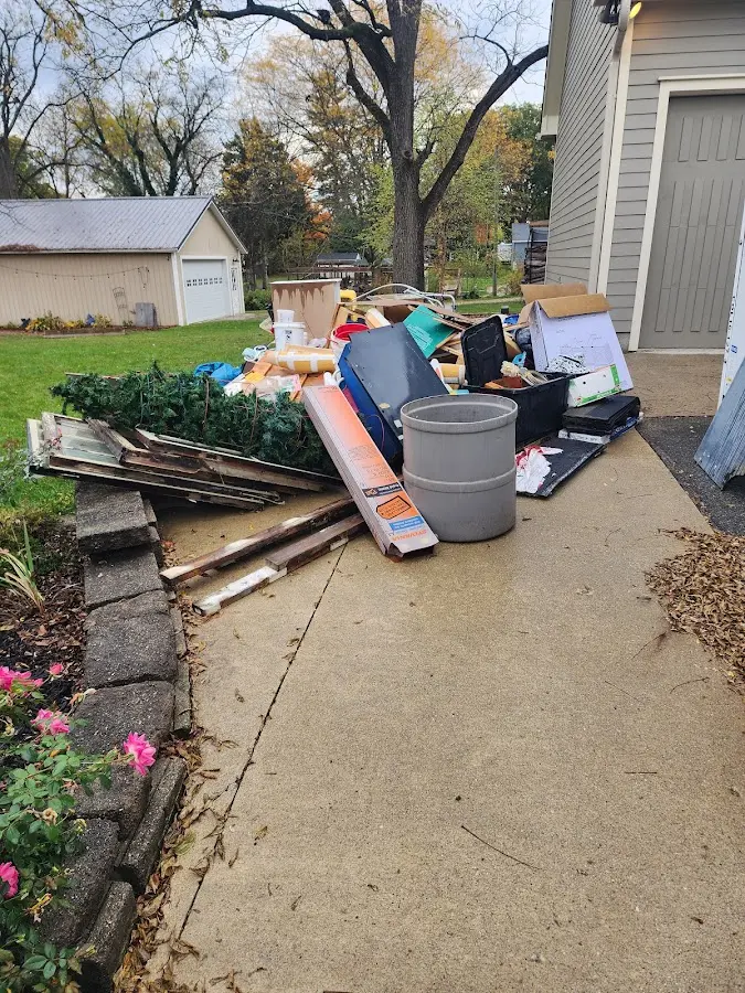 Dumpster being loaded with debris for Commercial Dumpster Rental in Enid